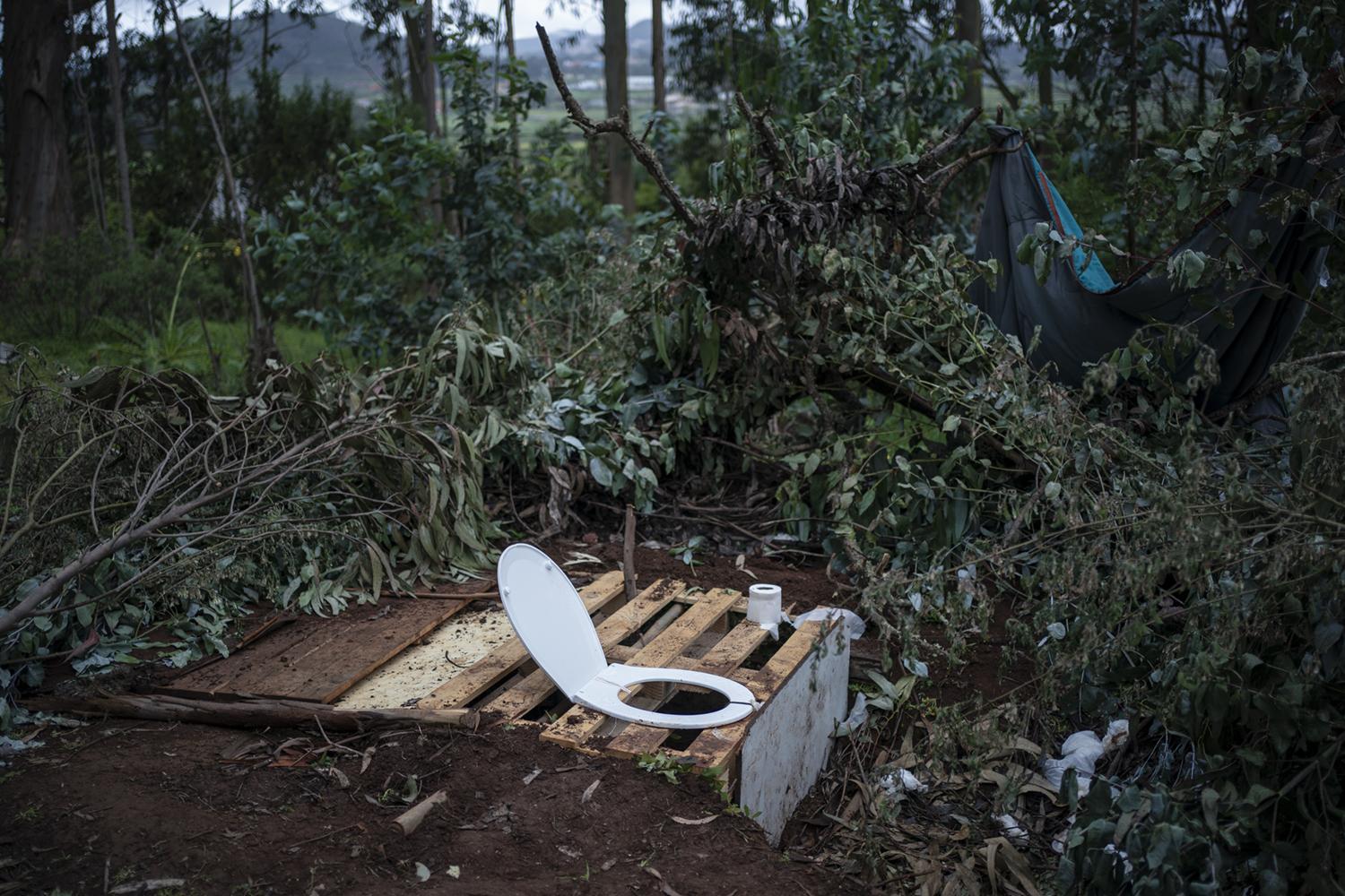 Las Raí­ces Camp - A makeshift toilet is pictured with a toilet seat on a...