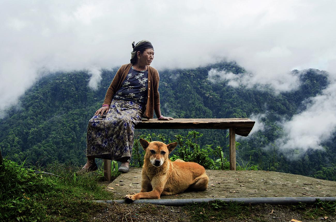Portrait of a Gorkha Lady and her pet in Rikisum, West Bengal.