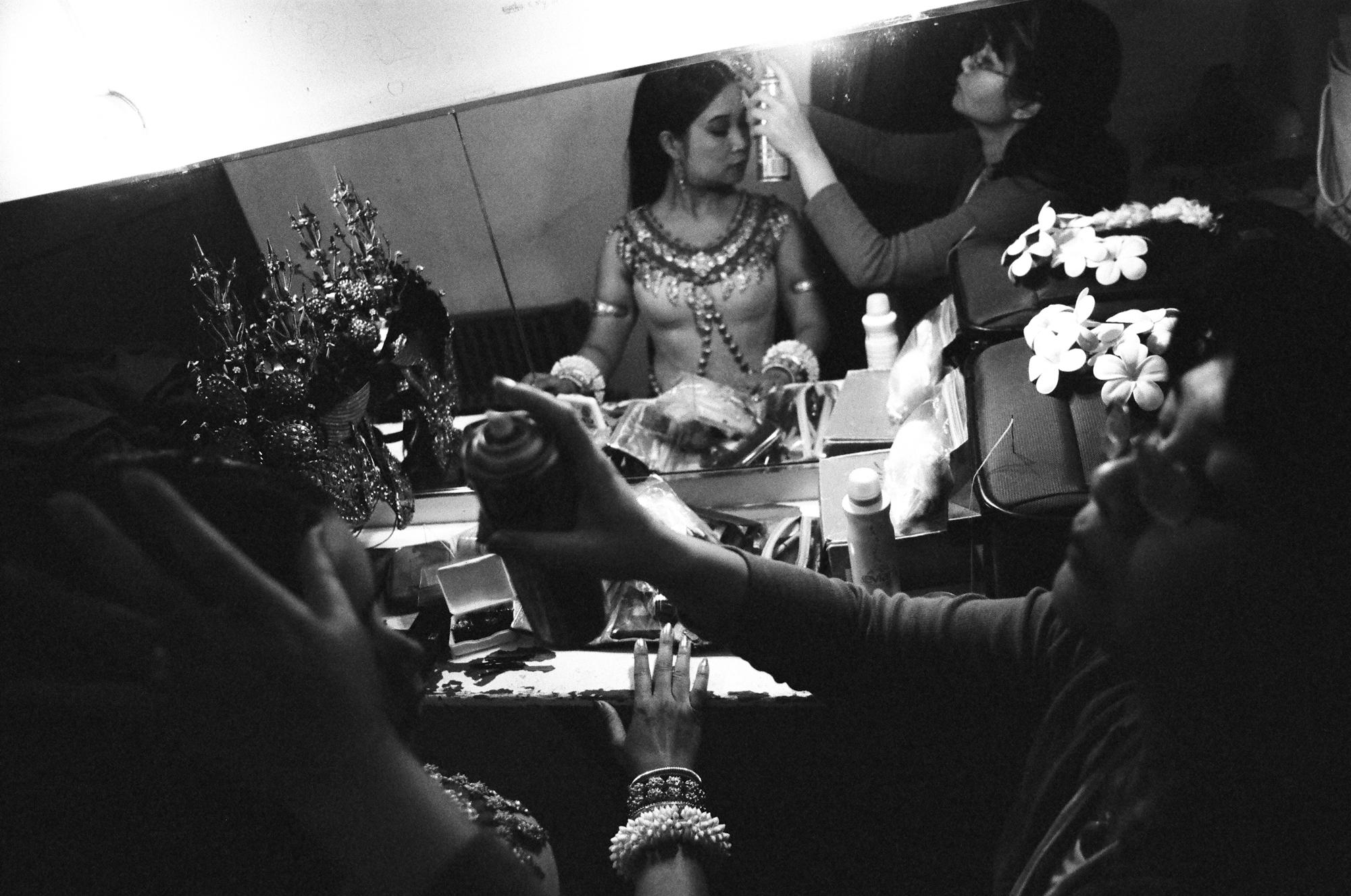 Celebrated Cambodian Dancer Charya Burt in the dressing room. Her sister spends two hours hand sewing her costume on before every one of her performances. As a member of Cambodia&rsquo;s Royal Dance Troupe, Charya toured nationally and internationally. After emigrating in 1993, Charya has been performing throughout the United States, including the Getty Museum in Los Angeles, the Kennedy Center in Washington DC, the San Francisco Opera House and countless times as a featured dancer at the San Francisco Ethnic Dance Festival. Her original works have been presented by the Jacob&rsquo;s Pillow Dance Festival, World Arts West, CounterPULSE, UC Santa Barbara, San Francisco Asian Art Museum, Oregon Shakespeare Festival, and many others. Charya holds a B.A., Cum Laude, from Sonoma State University and has conducted dance workshops at schools and colleges around the country. Charya is also a recipient of the Isadora Duncan Award for Individual Performance.