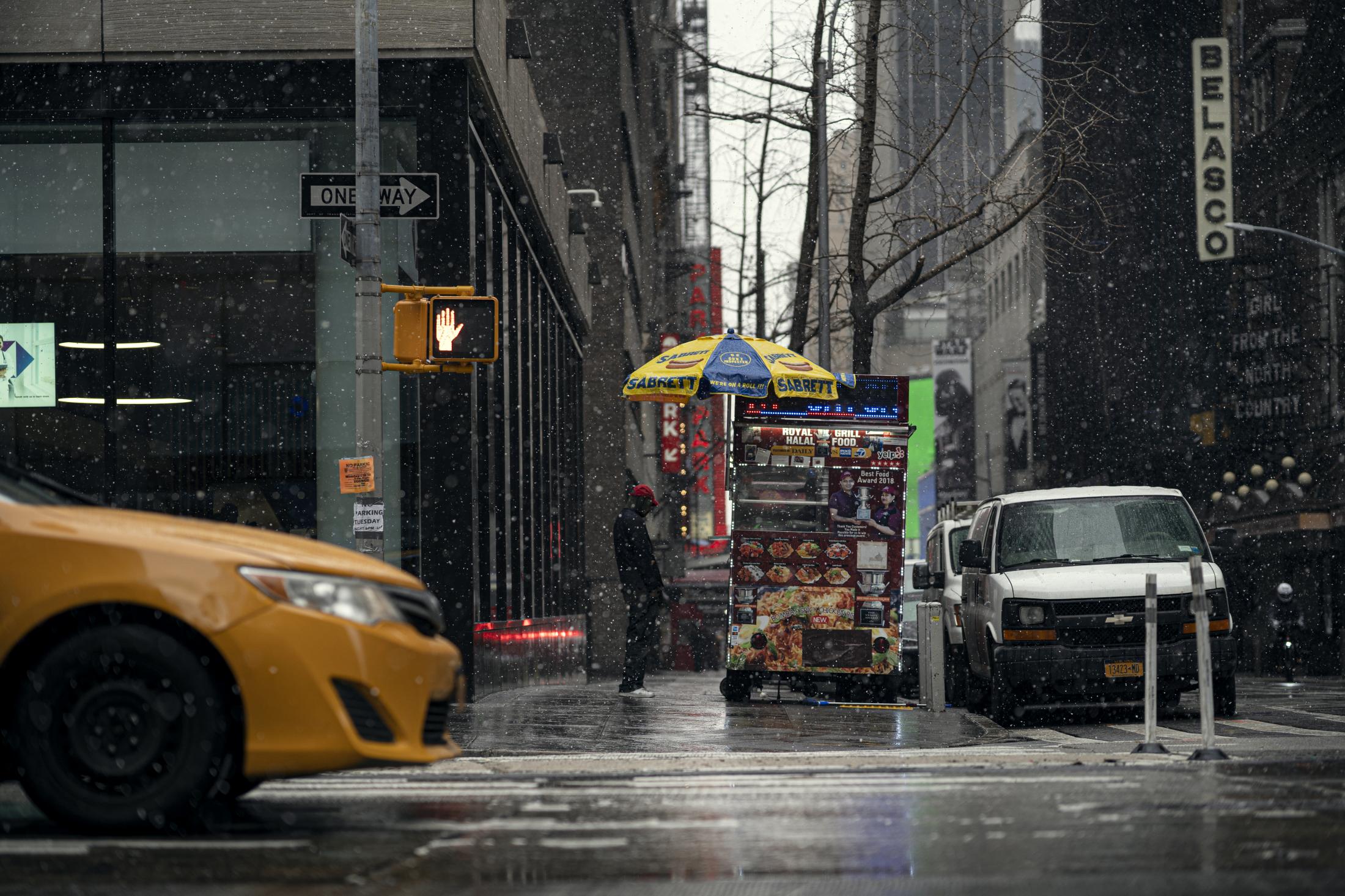 A customer waits for his food in the snow at MD Alamï¿½s Bangladeshi food cart on Tuesday, January 26, 2020. MD Alam is among the street vendors in the city hoping to legally obtain licenses to sell food on the street.