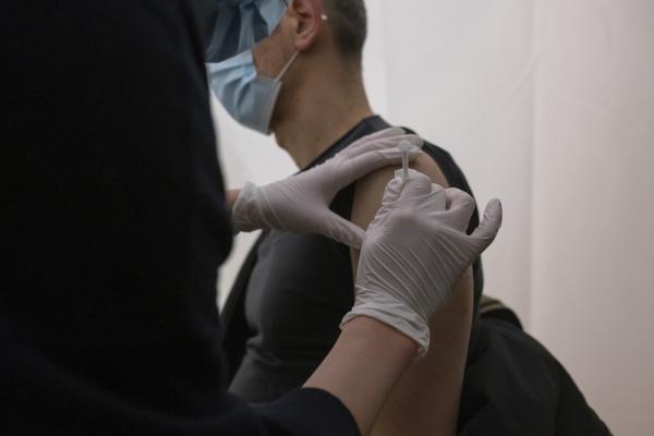 A man, being vaccinated against covid 19, a coronavirus, by a nurse who injects his first dose of vaccine into his arm, at the vaccinodrome, of the Stade de France, in Saint-Denis, in the 93, suburb next to Paris, on April 7, 2021. Antoine Wdo / Hans Lucas Un homme, se faisant vacciner contre la covid 19, coronavirus, par un infirmier qui lui injecte sa premiere dose de vaccin dans le bras, au vaccinodrome, du Stade de France, a Saint-Denis, dans le 93, en banlieue a cote de Paris, le 7 avril 2021. Antoine Wdo / Hans Lucas