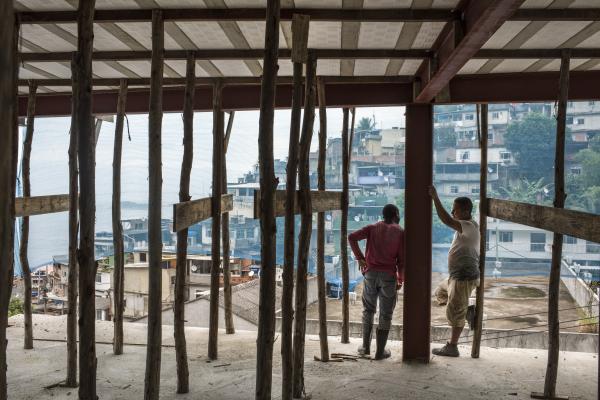 Vidigal - Workers chat at the construction site of a new commercial...