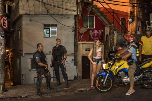 Vidigal - Police officers and locals cruise along the main road...