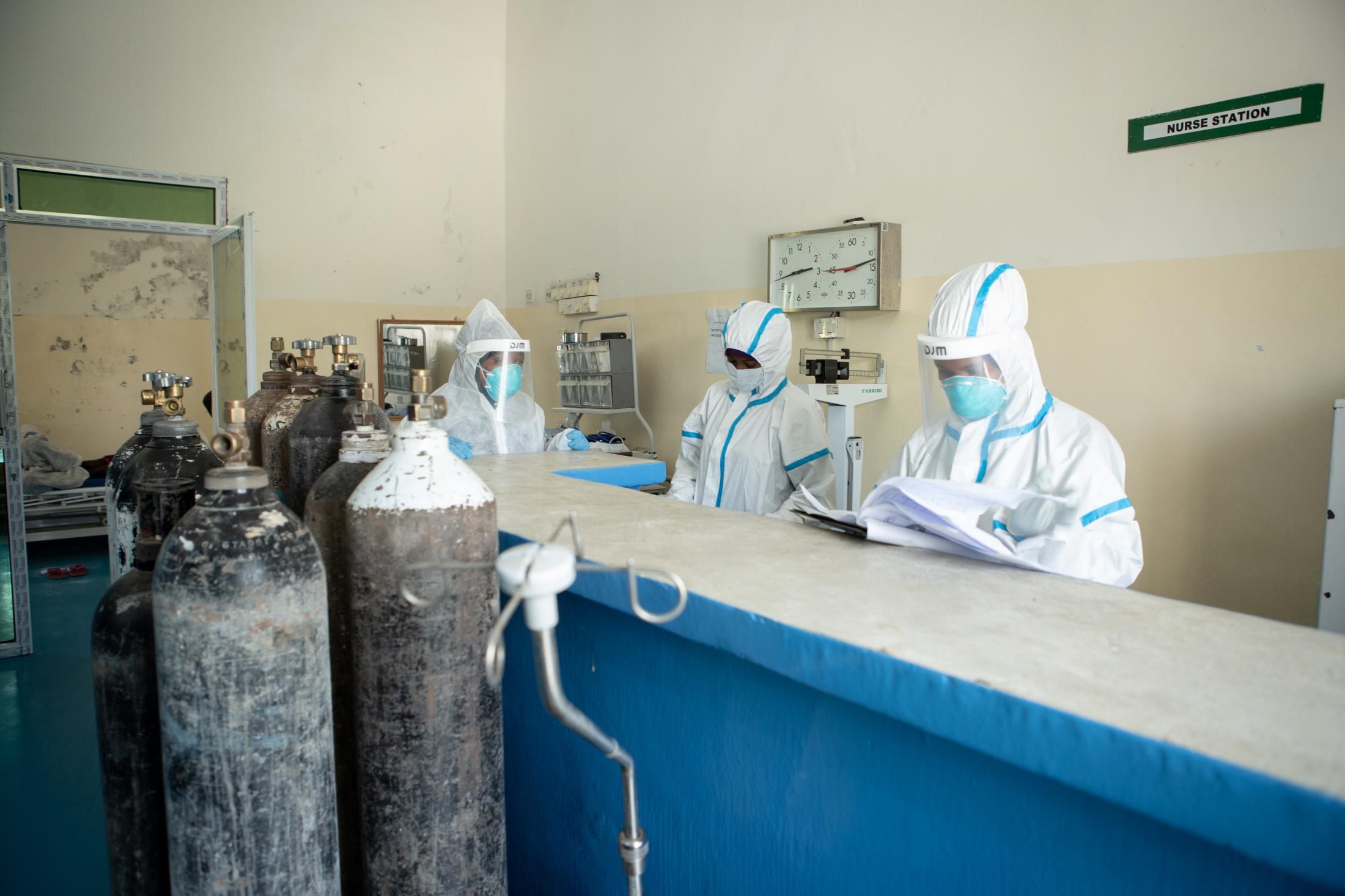 A day at a COVID -19 treatment centre in Somalia - Nurses work from the counter where they monitor the...