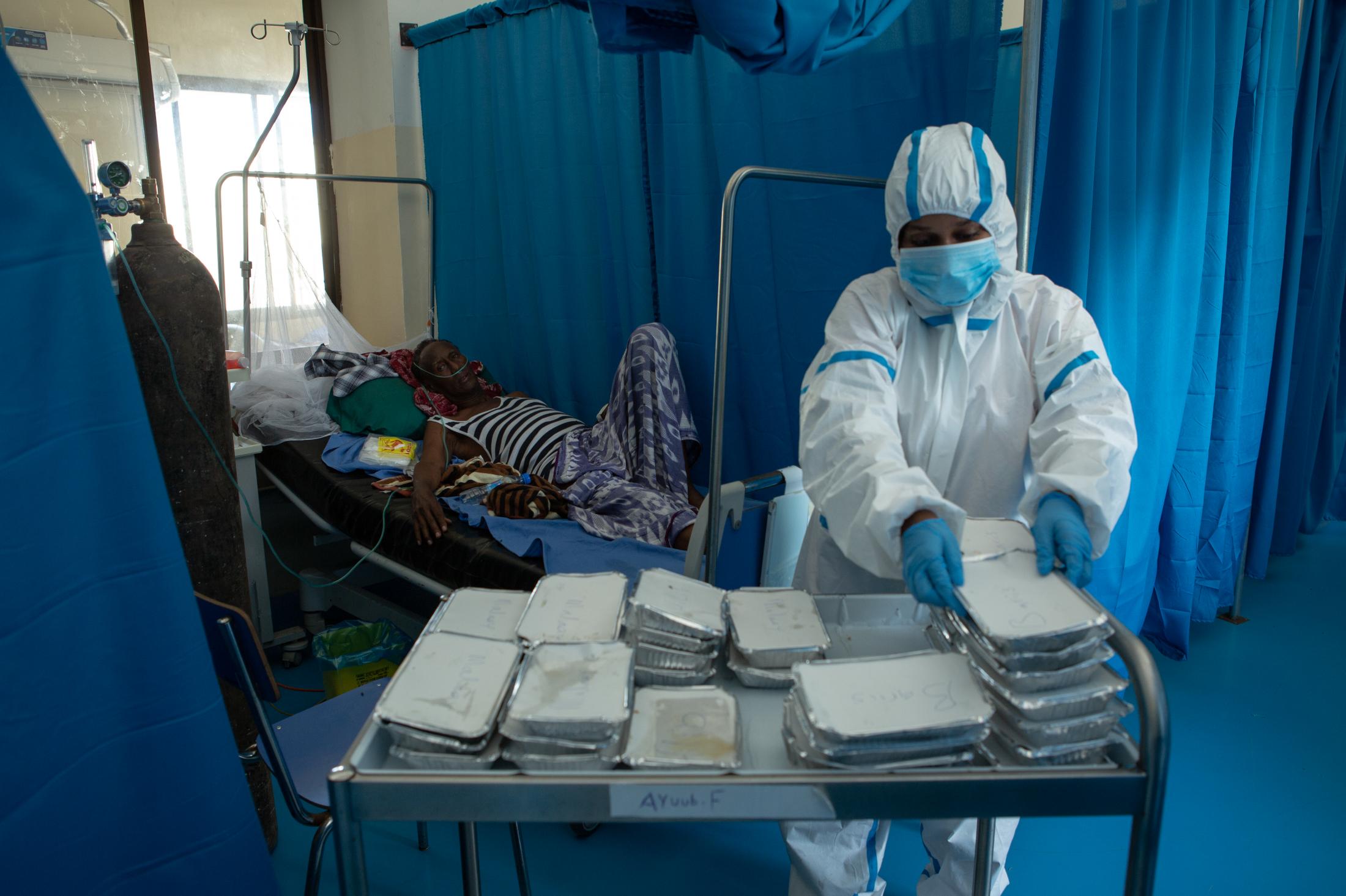 A day at a COVID -19 treatment centre in Somalia - A nurse serves lunch to a patient at the treatment ward...