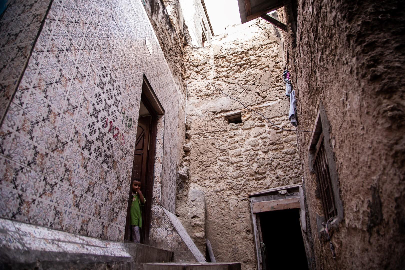 Narrow Alleys of Xamar Weyne - A young girl stands outside their house in the ancient...