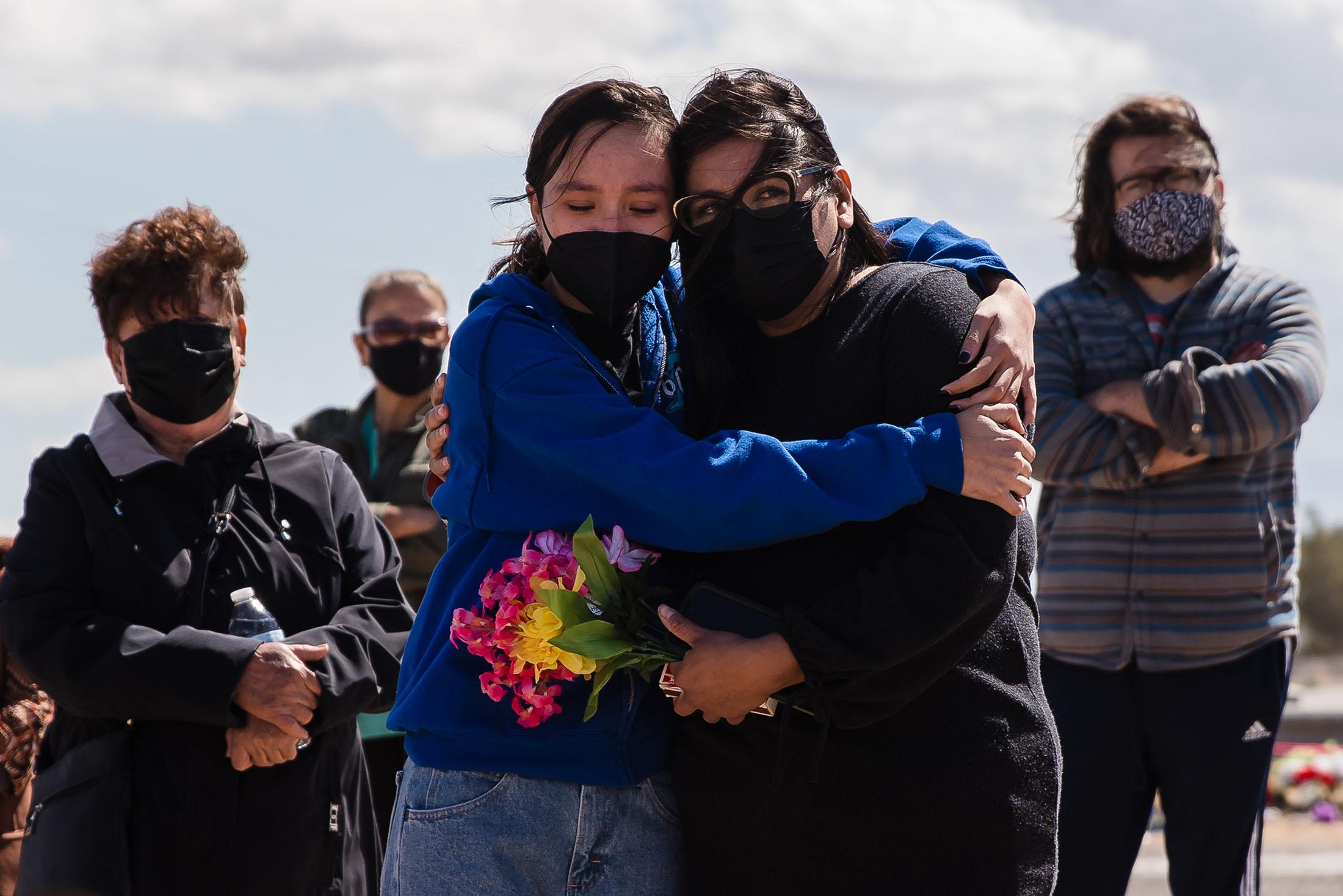 Tori Bosmenier (left) hugs Carmina Ramirez (right) at a vigil on March 10, 2021 at the crash site for the 13 undocumented immigrants who lost their lives in early March.