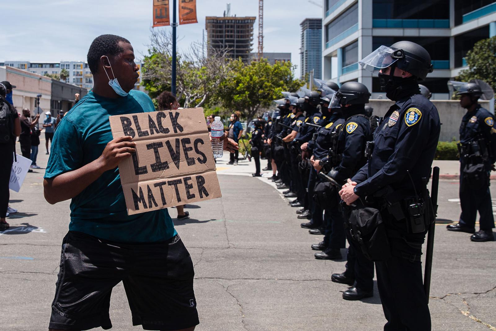 Image from United States - A man holds a "Black Lives Matter" sign in...