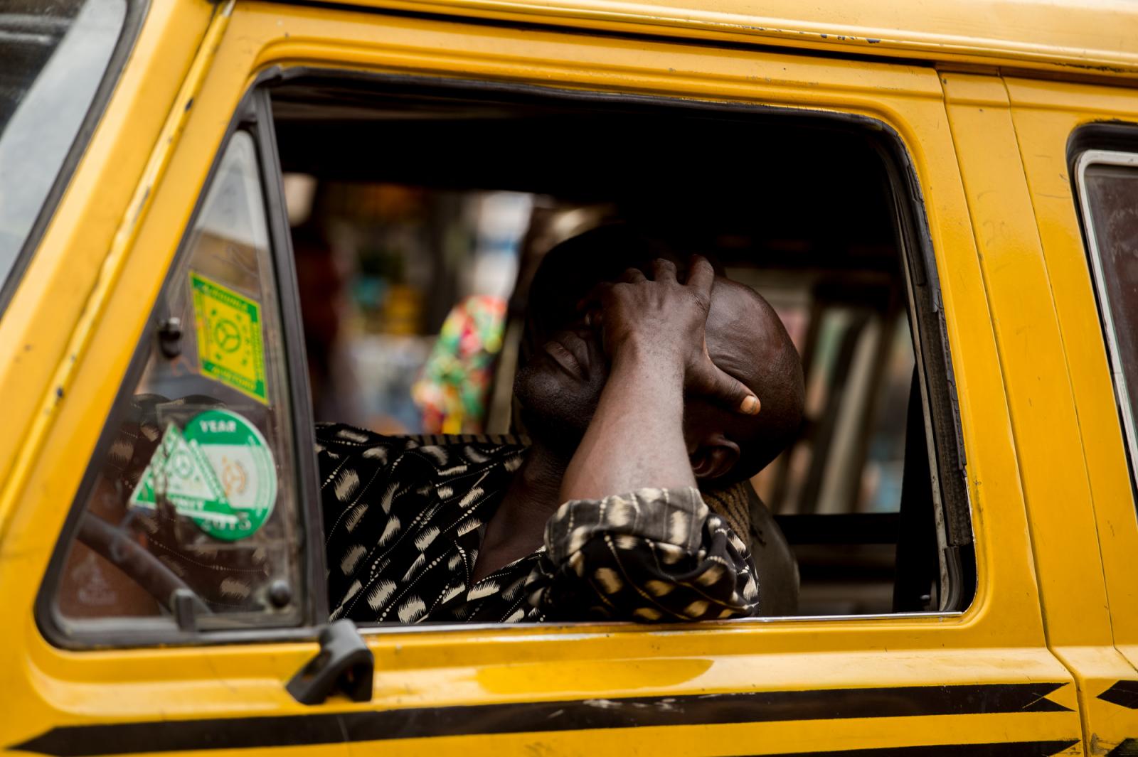 A bus driver sleeps off while in traffic in Lagos, Nigeria.