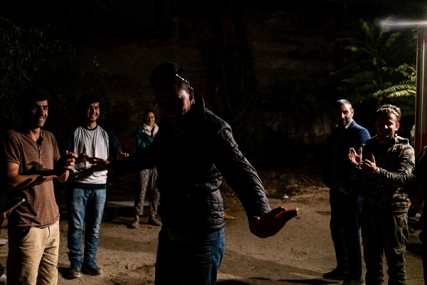 Image from HIDDEN BEHIND THE RAILROAD - Time to show off, a refugee dancing in an abandoned area...