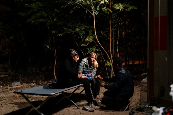 HIDDEN BEHIND THE RAILROAD - An Afghan refugee receives medical treatments with the...