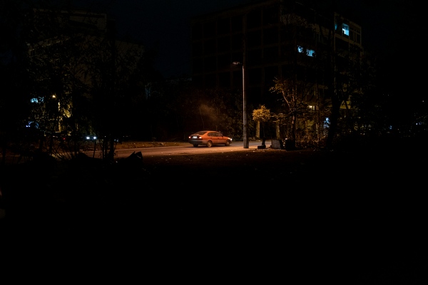 Image from HIDDEN BEHIND THE RAILROAD - A car pass by the empty field in an abandoned area of...