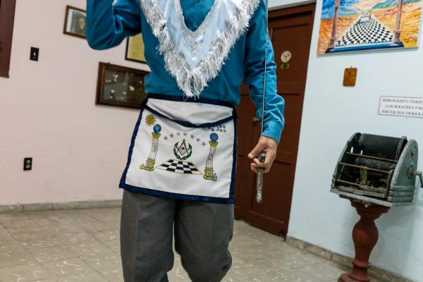 LA ISLA - CUBAN DIARIES - A Freemason in the lobby of his temple. He makes sure I...