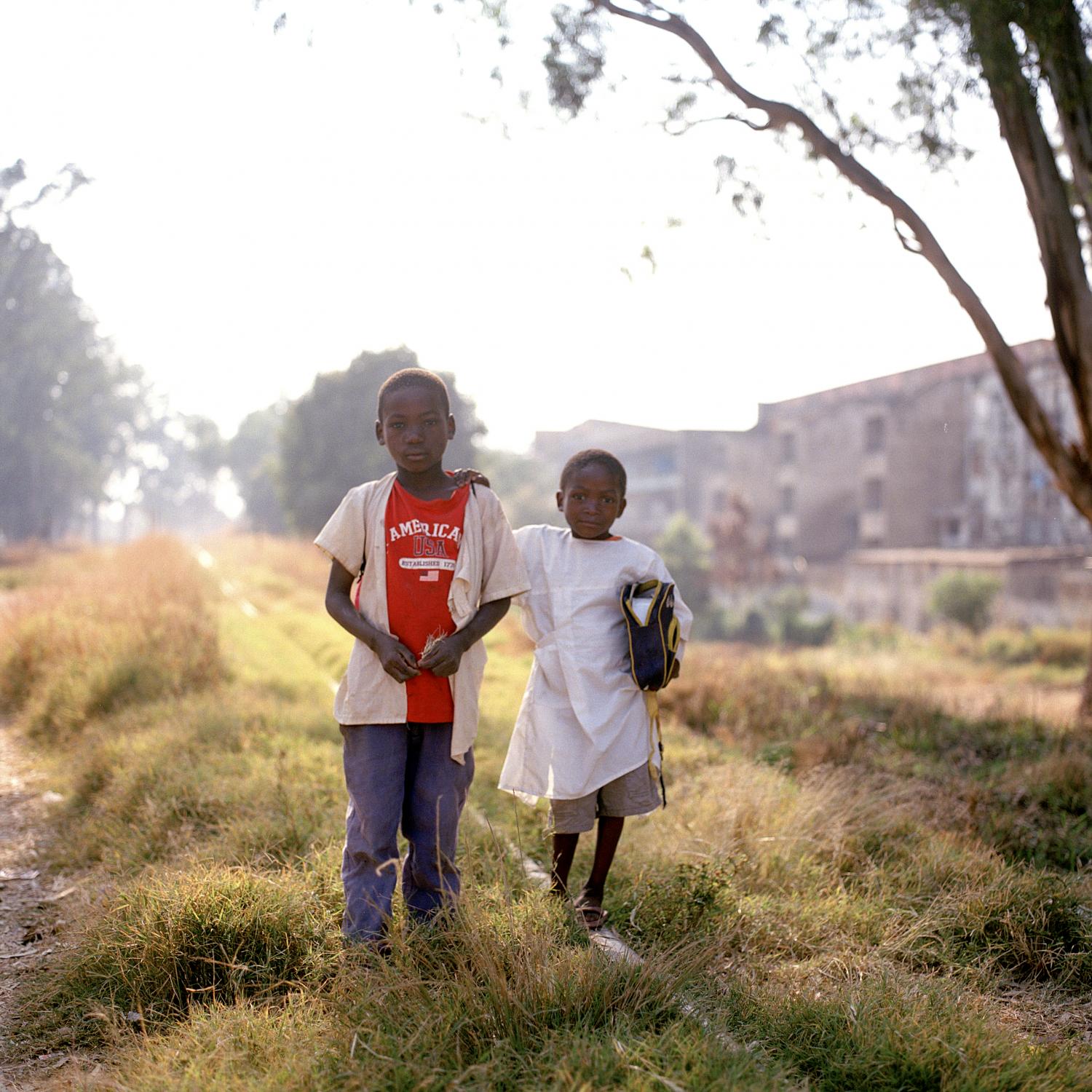 Angola - Students dodge class strolling along the tracks of the...
