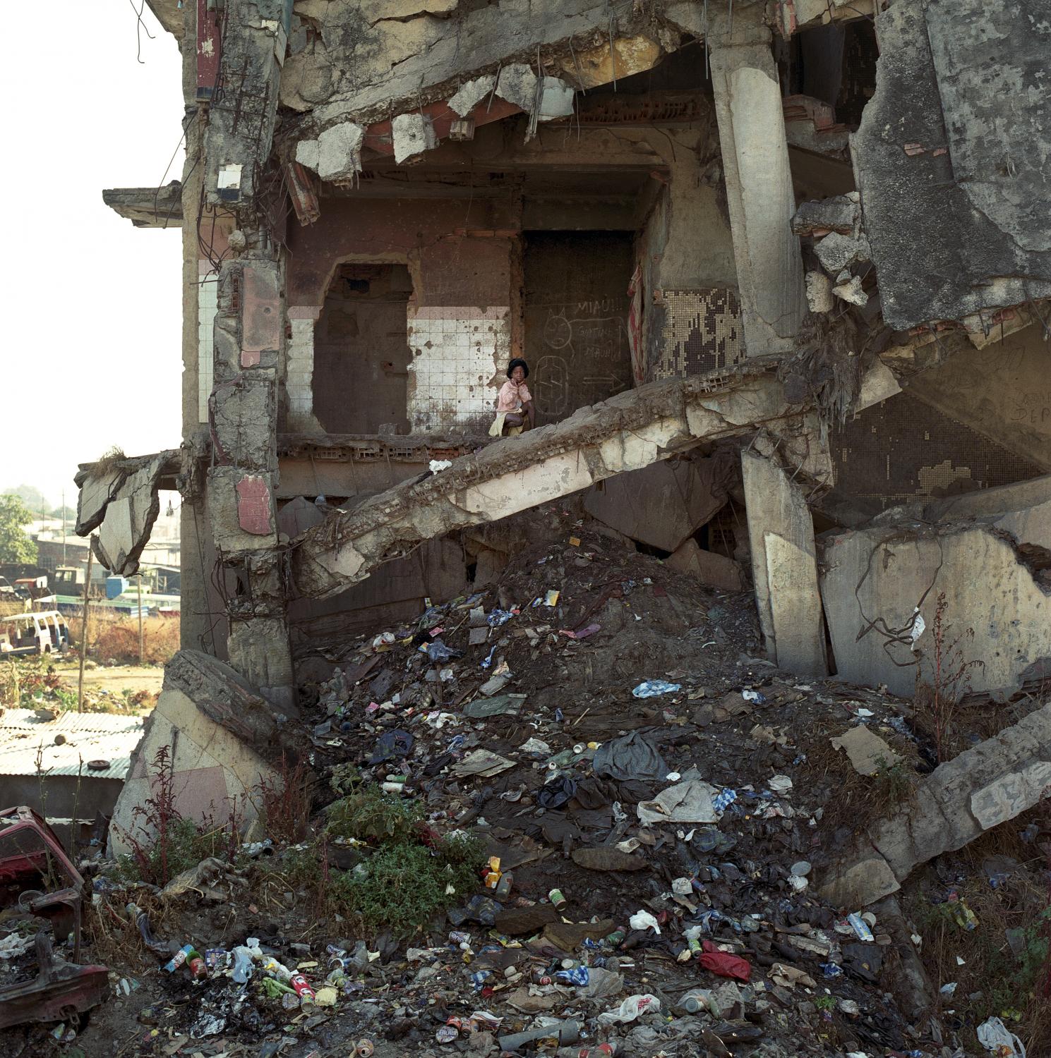 Angola - A girl living in the ruins of a building destroyed during...