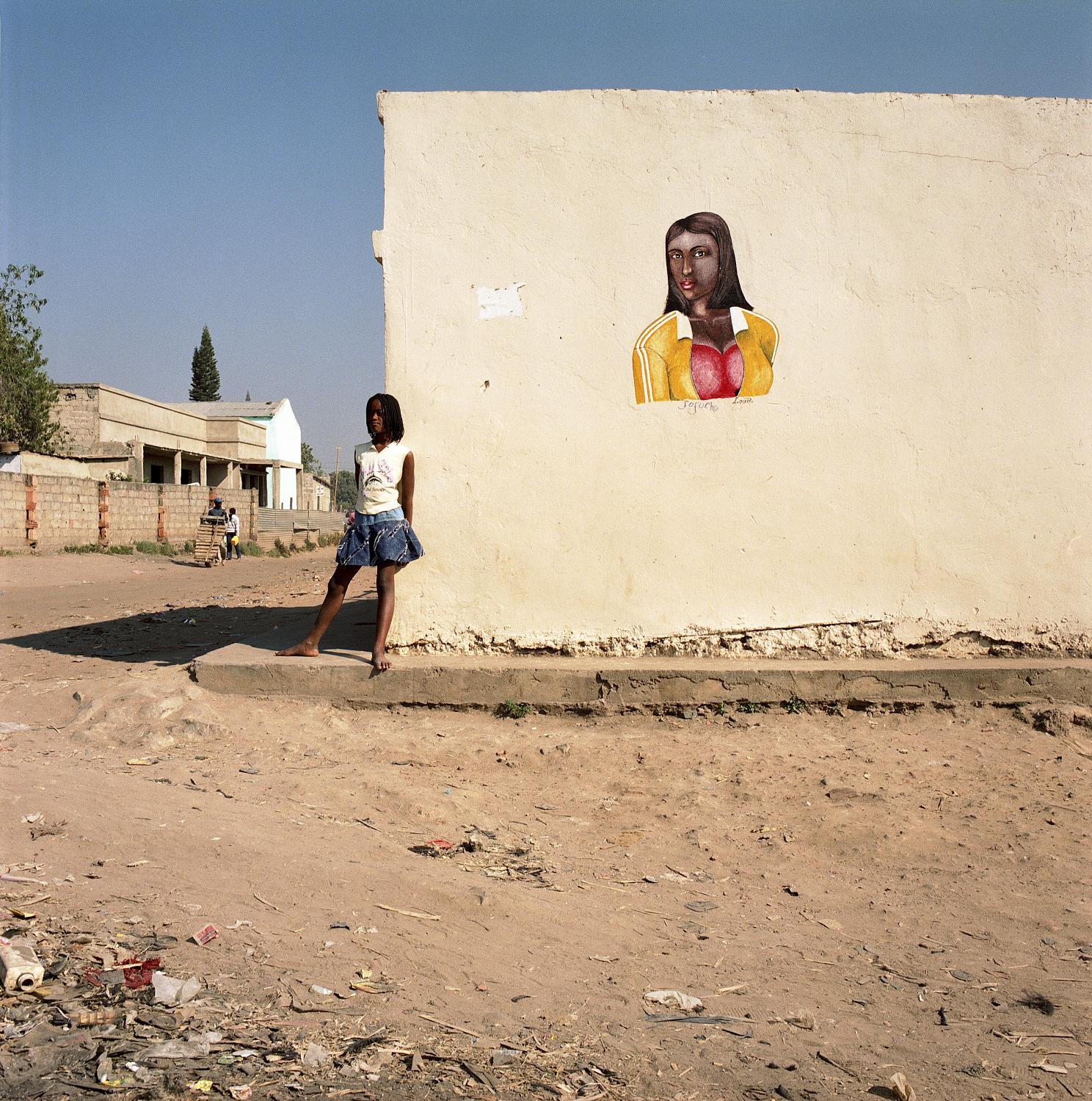 Angola - Girl on a street corner in Kuito, capital of Bié...