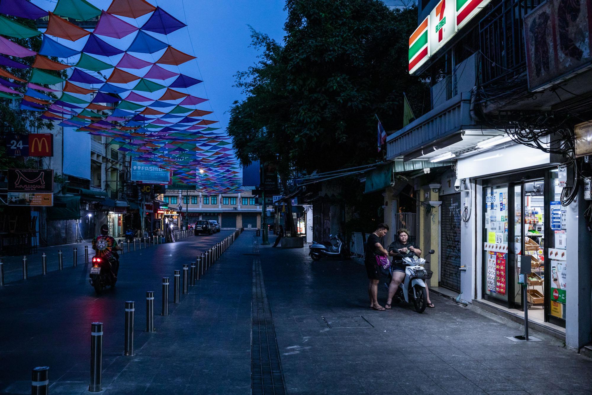 Covid-19: Thailand - A couple of people stop at 7/11 after dark on an...