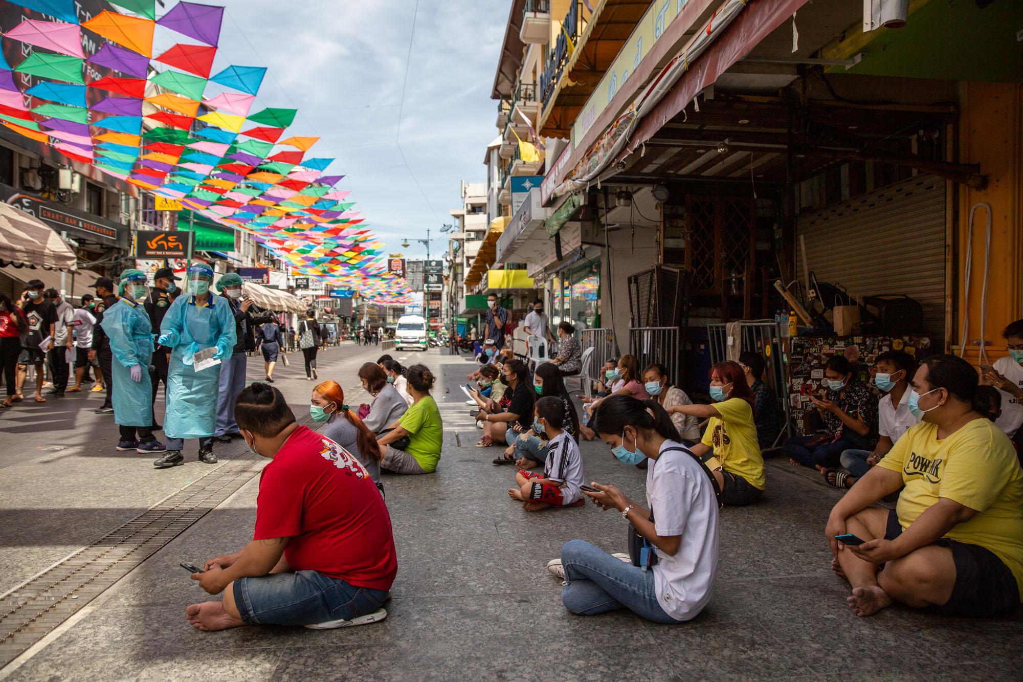 Covid-19: Thailand - High risk individuals sit on Khao San Road as they wait...