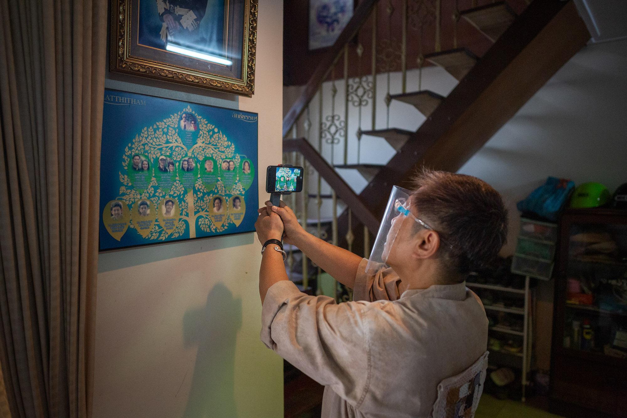 Step Into My (Home) Office: Rest Of World - Hnoi Latthitham, 53, shows participants her family tree...