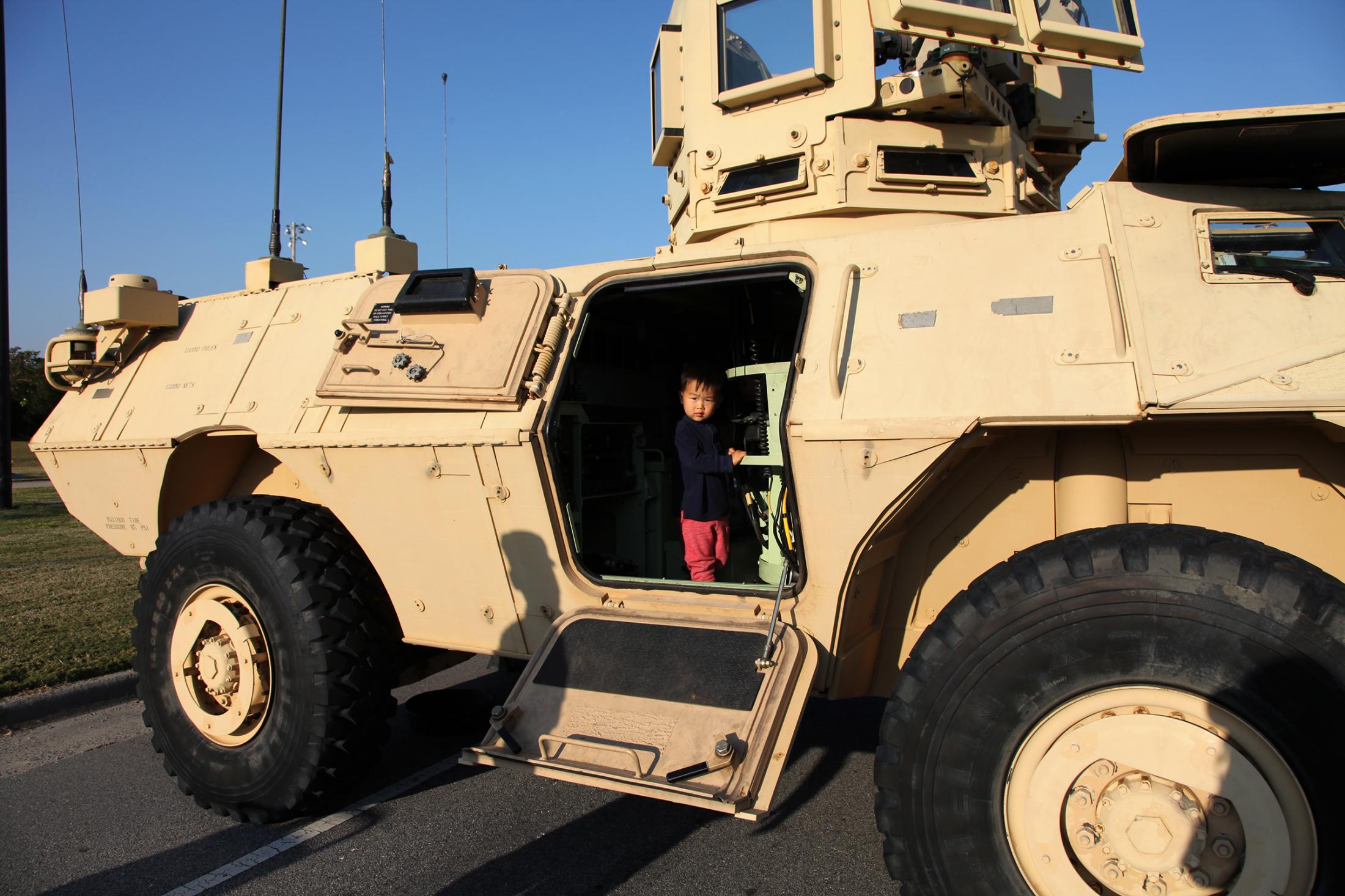 Motherhood and the Military - Teo climbs in an 1117 Armored Security Vehicle during a...