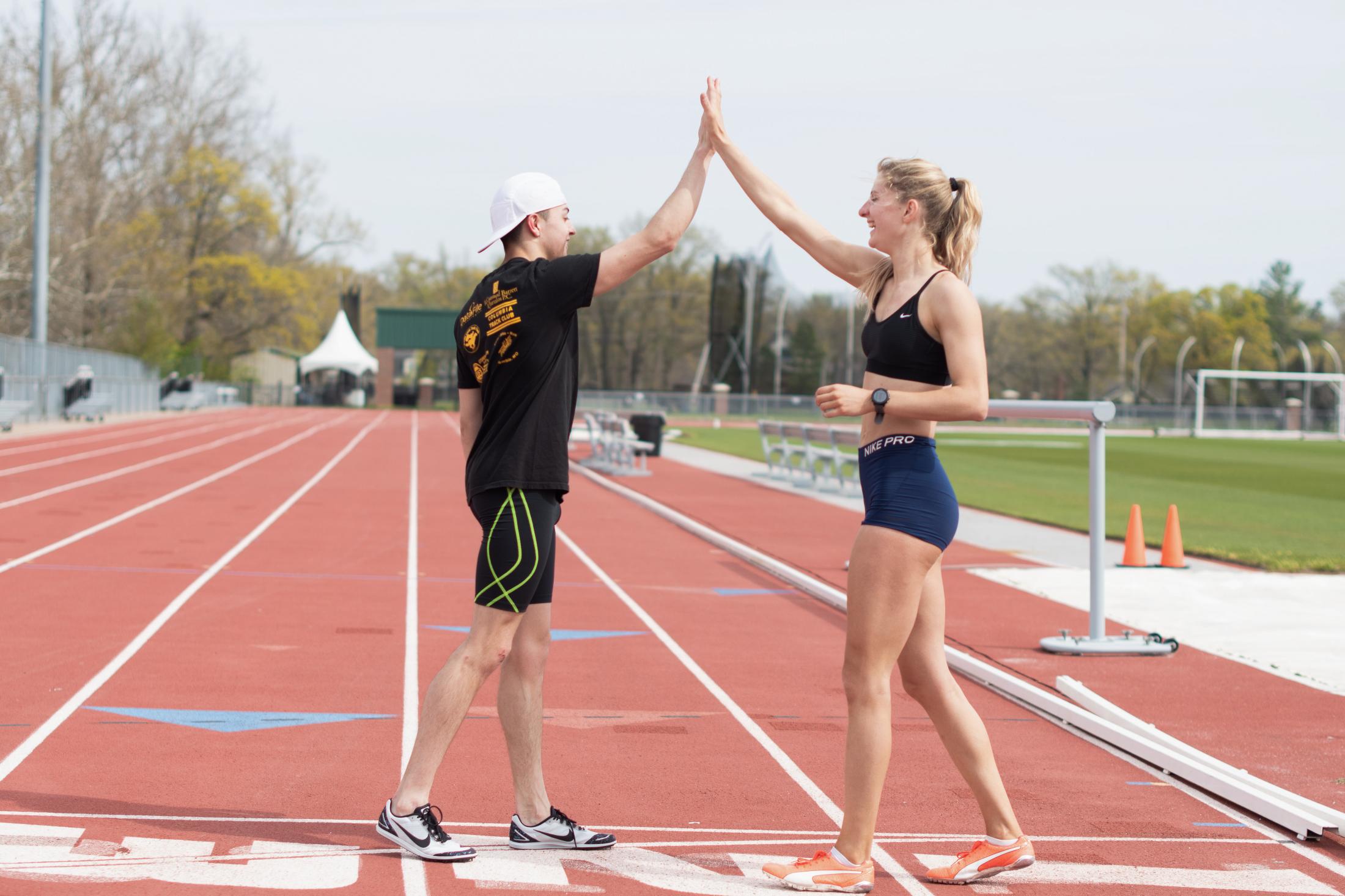 Pandemic Obstacles - Tess Losacker and Logan high-five after a successful...
