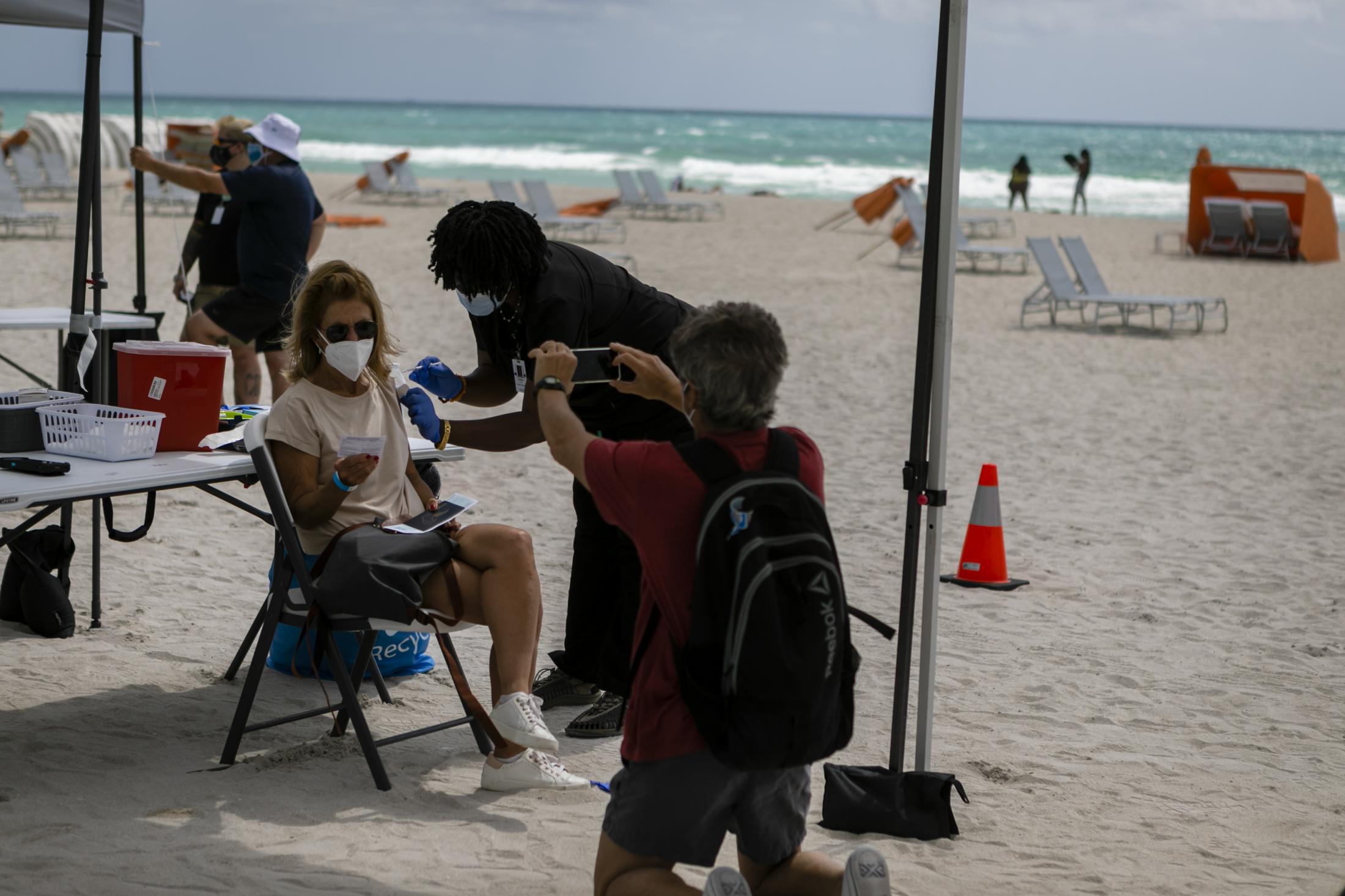 Tourists get Johnson & Johnson COVID-19 vaccine at Miami Beach - A woman receives a shot of Johnson & Johnson COVID-19...