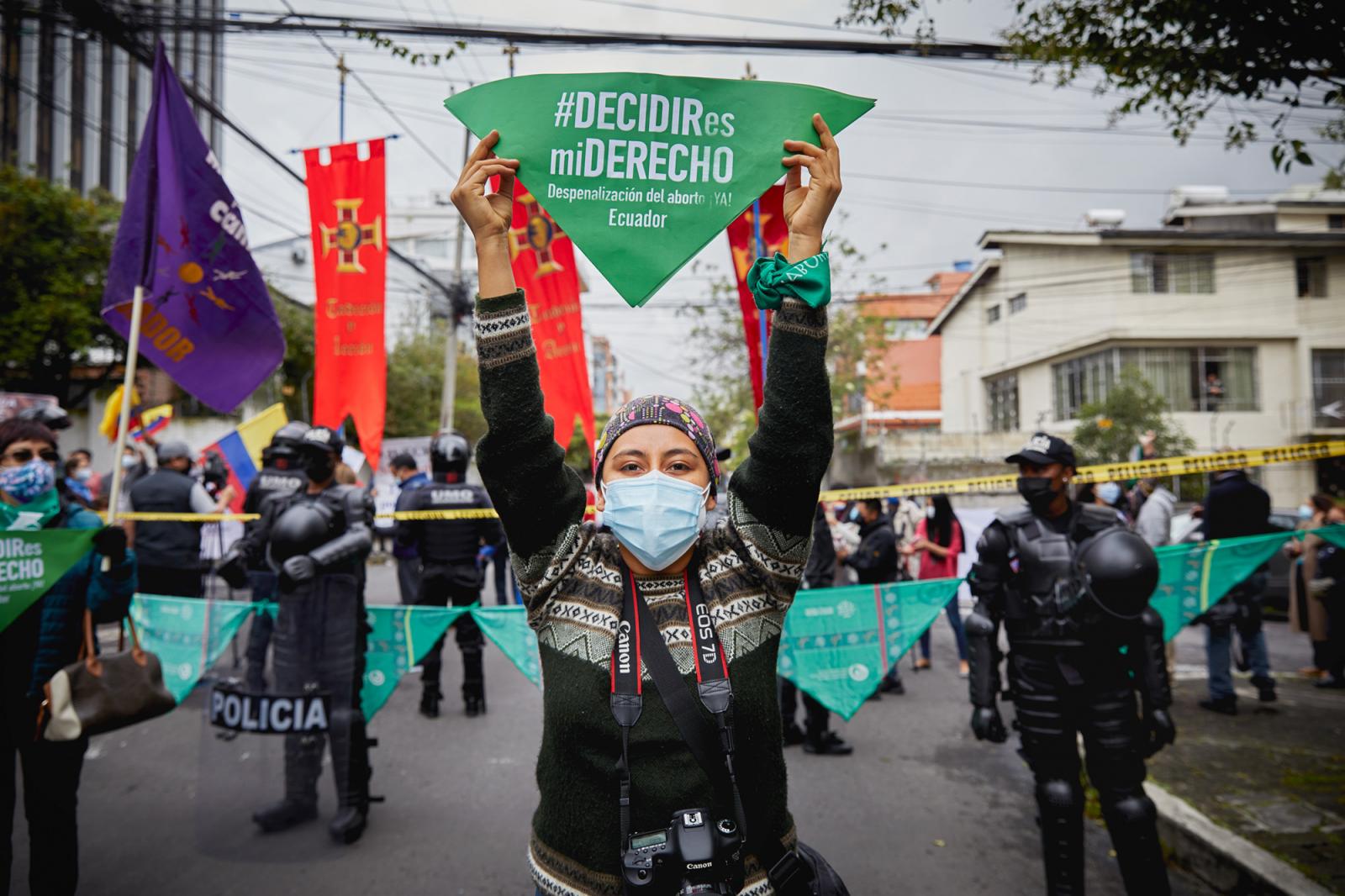 A young woman holds a sign that...April 28, 2021, Quito, Ecuador.