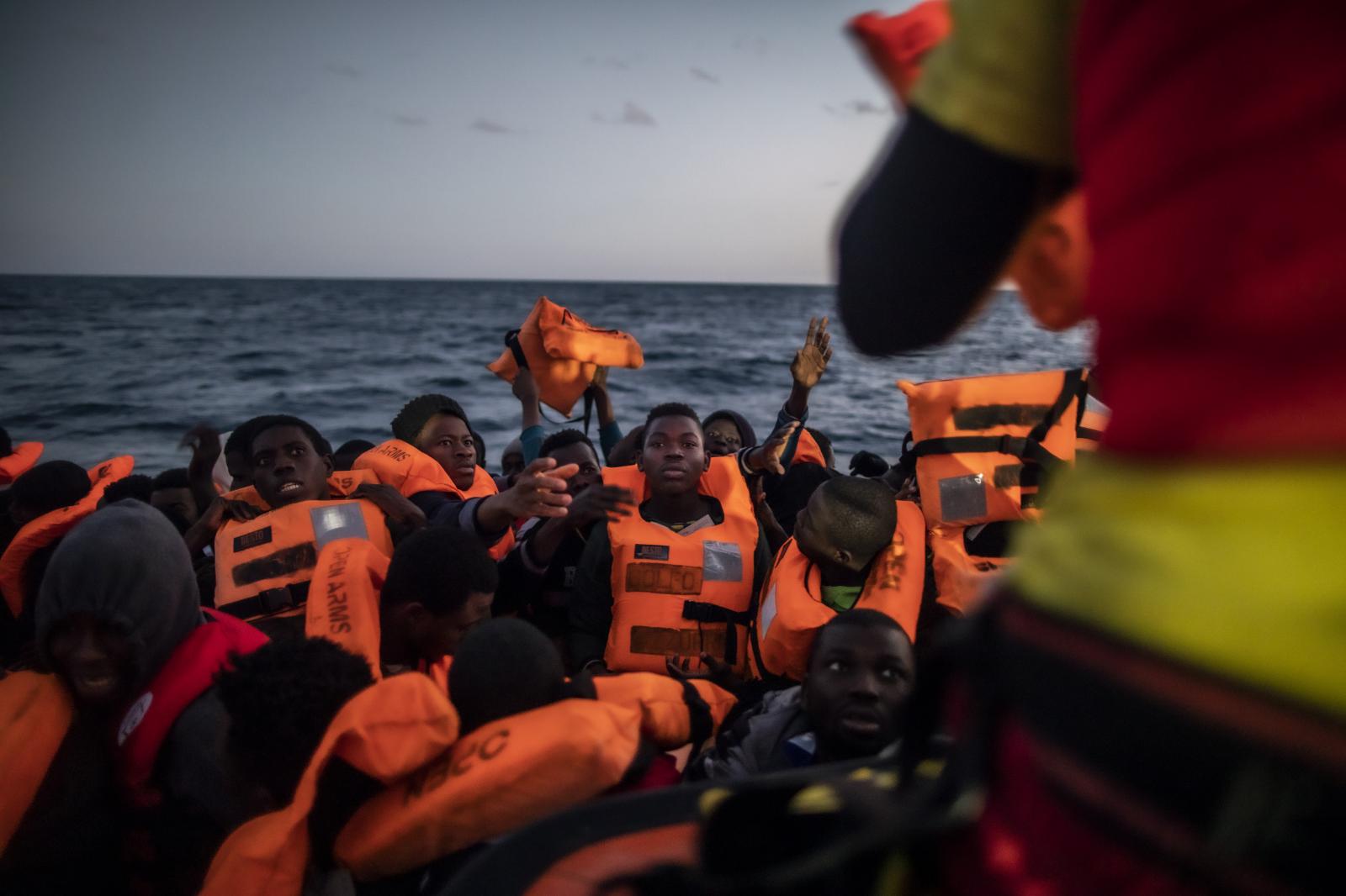 Fleeing the Libyan Clutches - Rescuer Alberto Agrelo distributes the waistcoats to all...