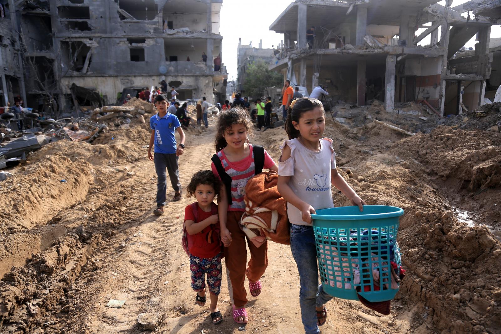 Children return to their destroyed homes in the town of Beit Hanoun after the bombing ended. May...