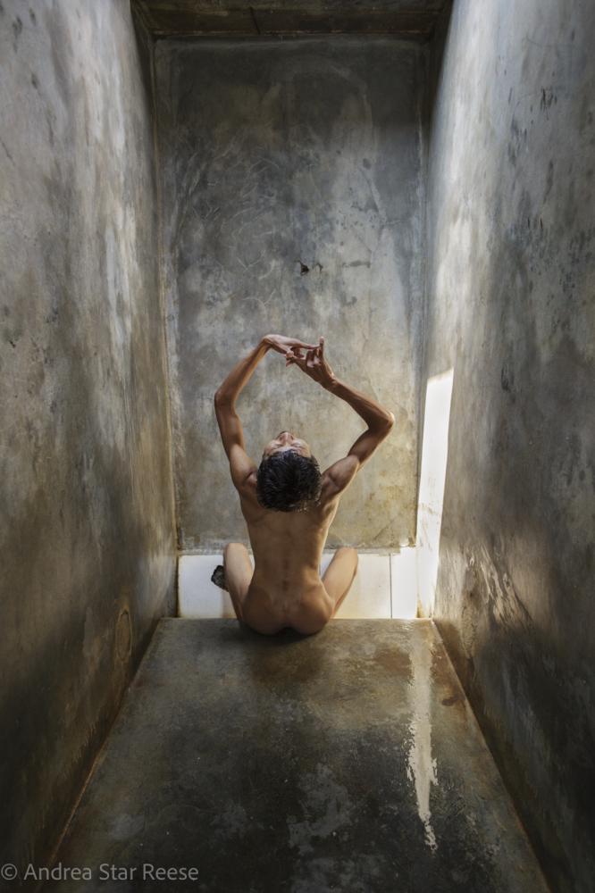 A man sings in his cell, his hands moving in an intricate dance, at Pengobatan Alternatif Jasono, a traditional healing center in Cilacap, Central...
