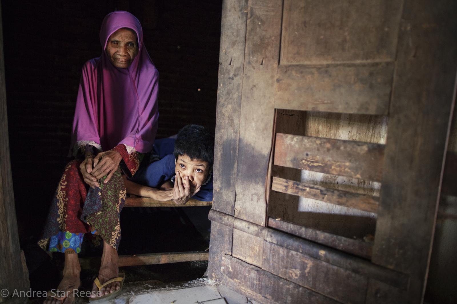 Disorder - Supilah sits next to her daughter Siti, in her 40's has...