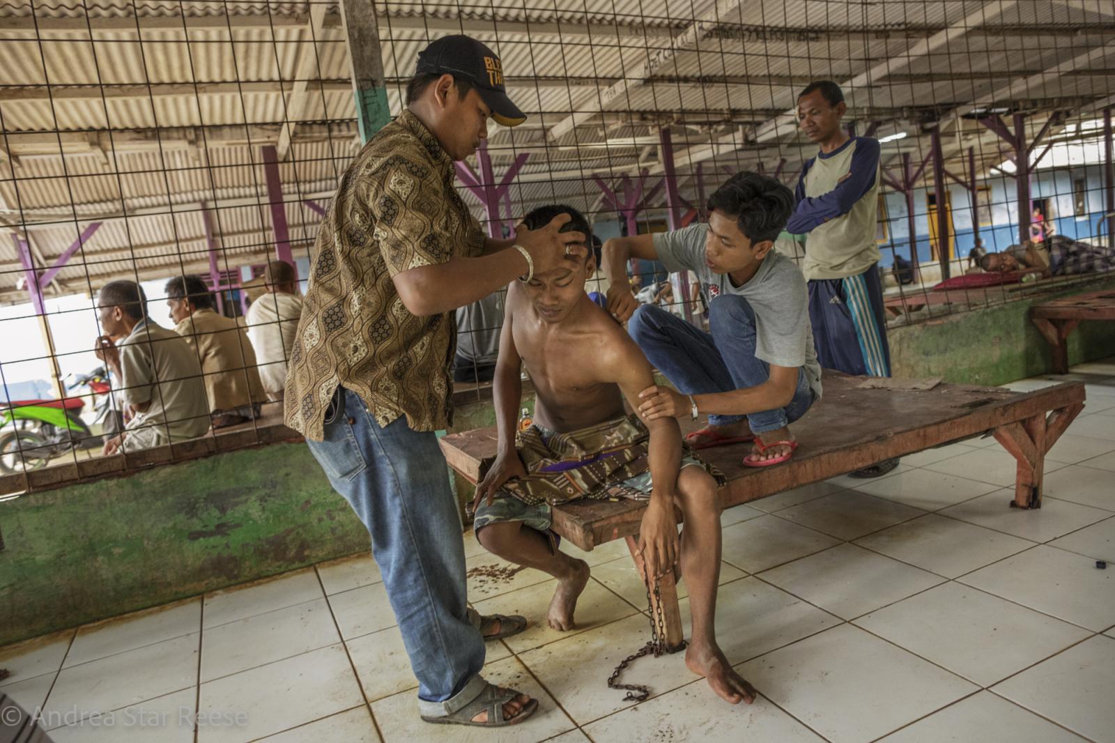 Disorder - A traditional healing method is used to assist a man in...