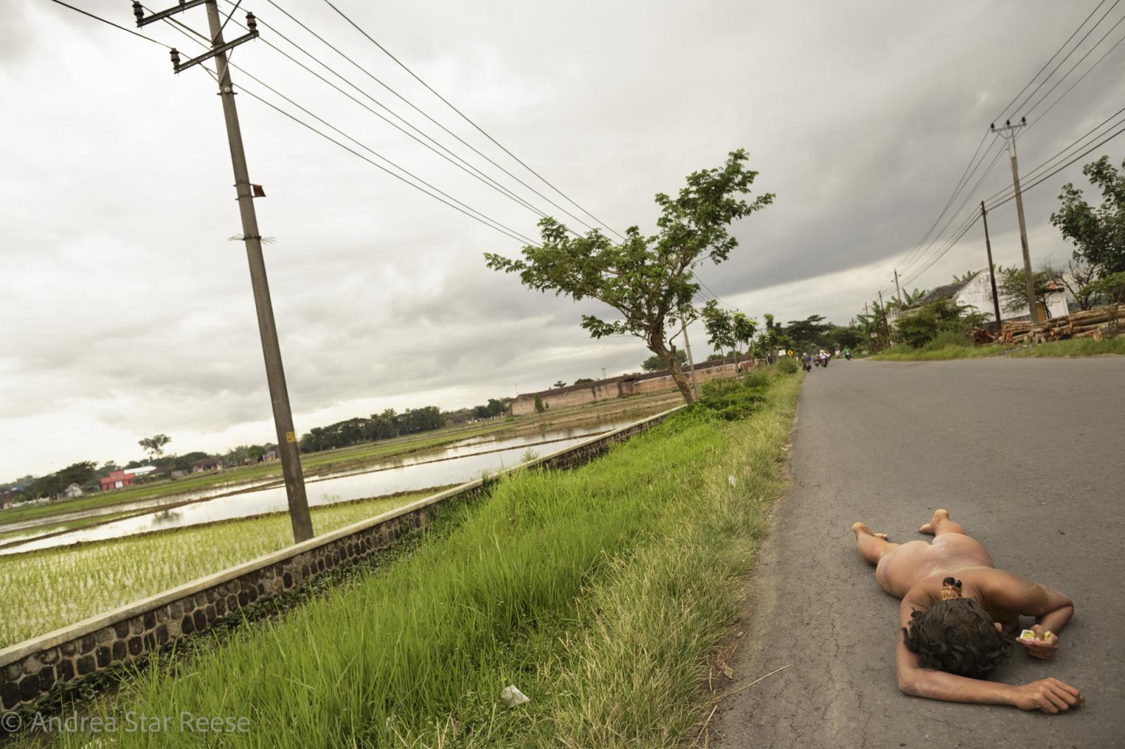 Disorder - A woman wanders lost on a road near Klaten, Central Java....
