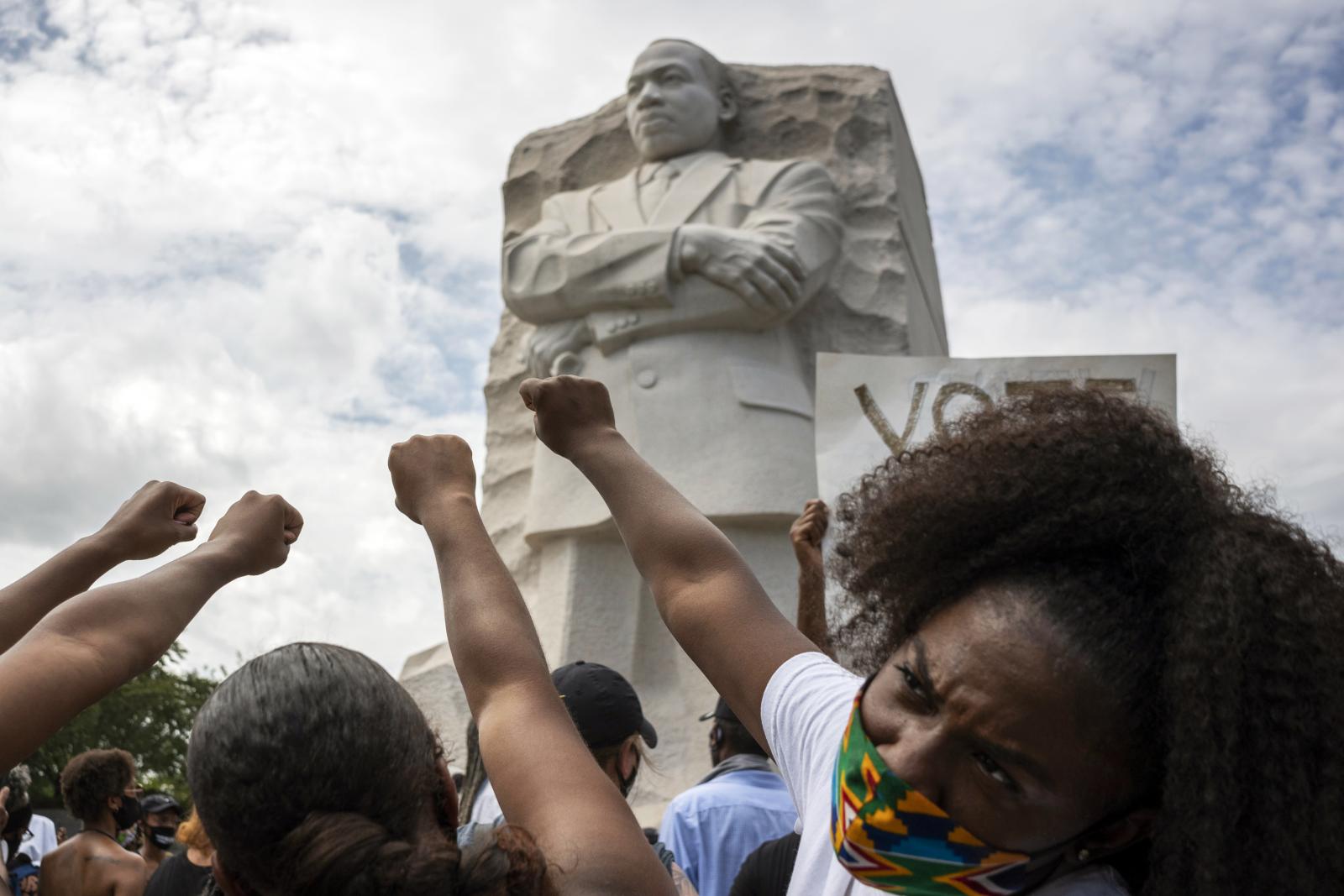Black women raise their fists i... previous civil rights leaders.