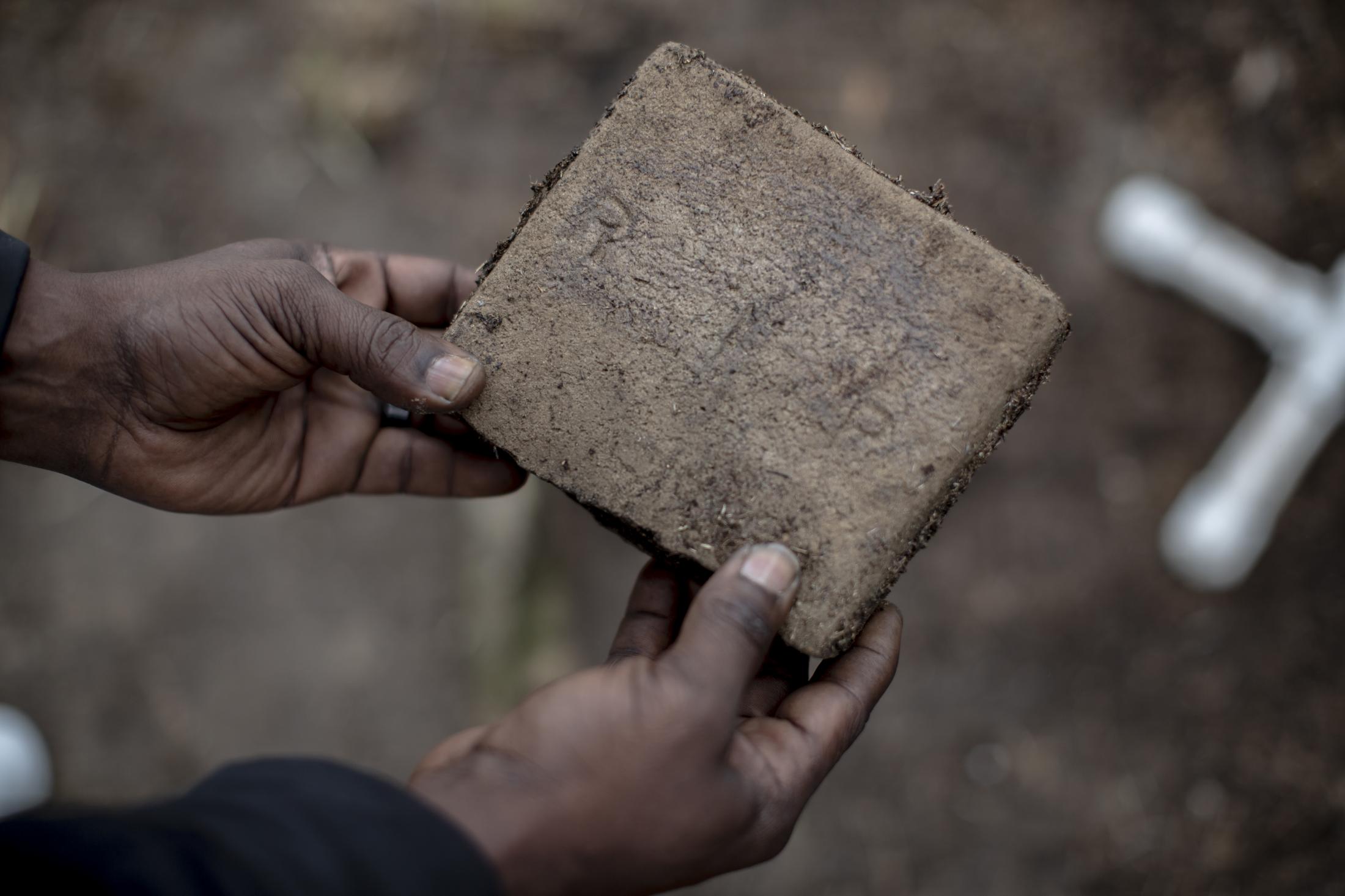 Growing From Tradition - Anthony Crawford holds a small gravestone that shows the...