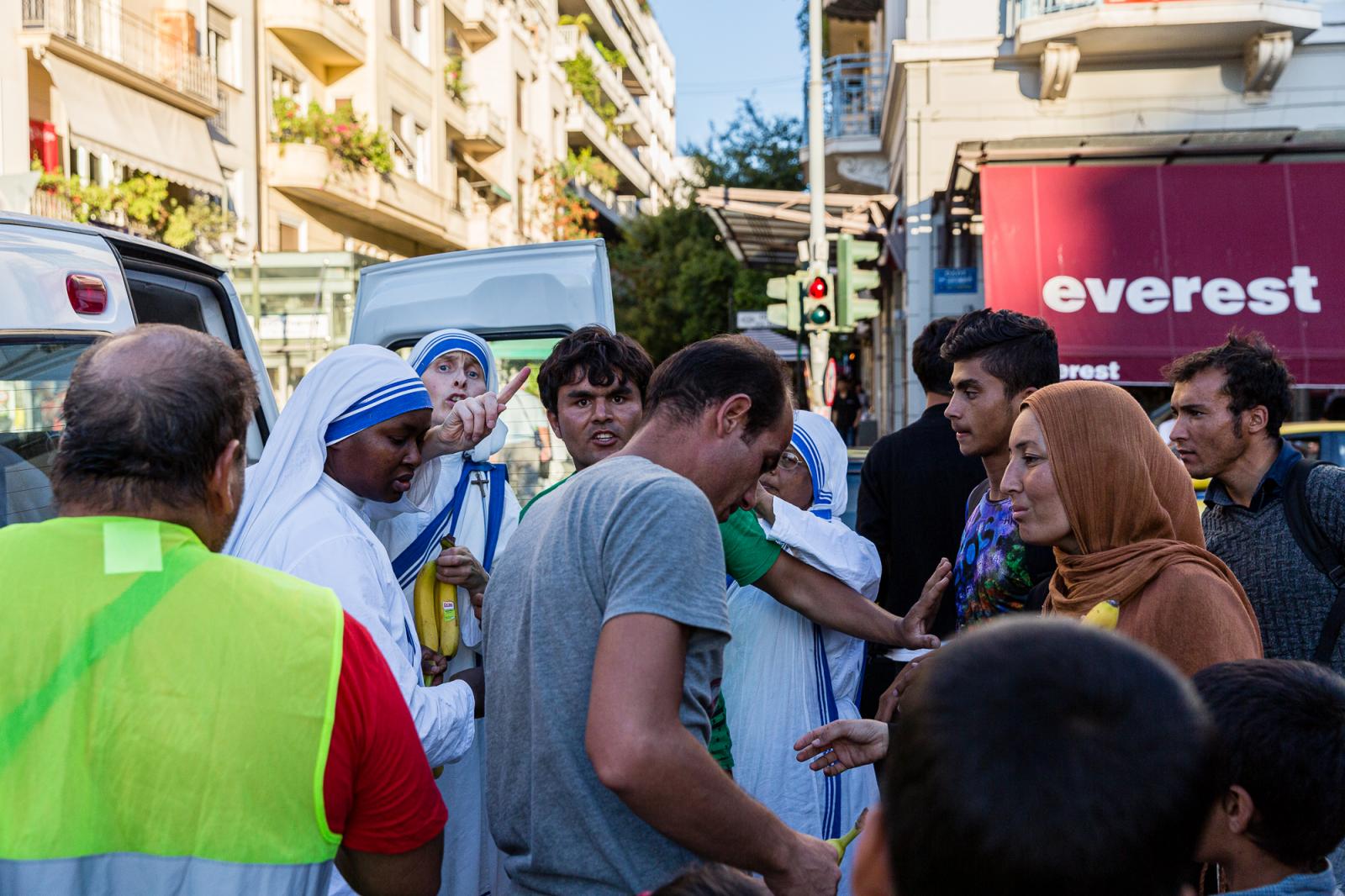 Nuns supply food to Afghan migr...ia square. Athens, Greece 2015.