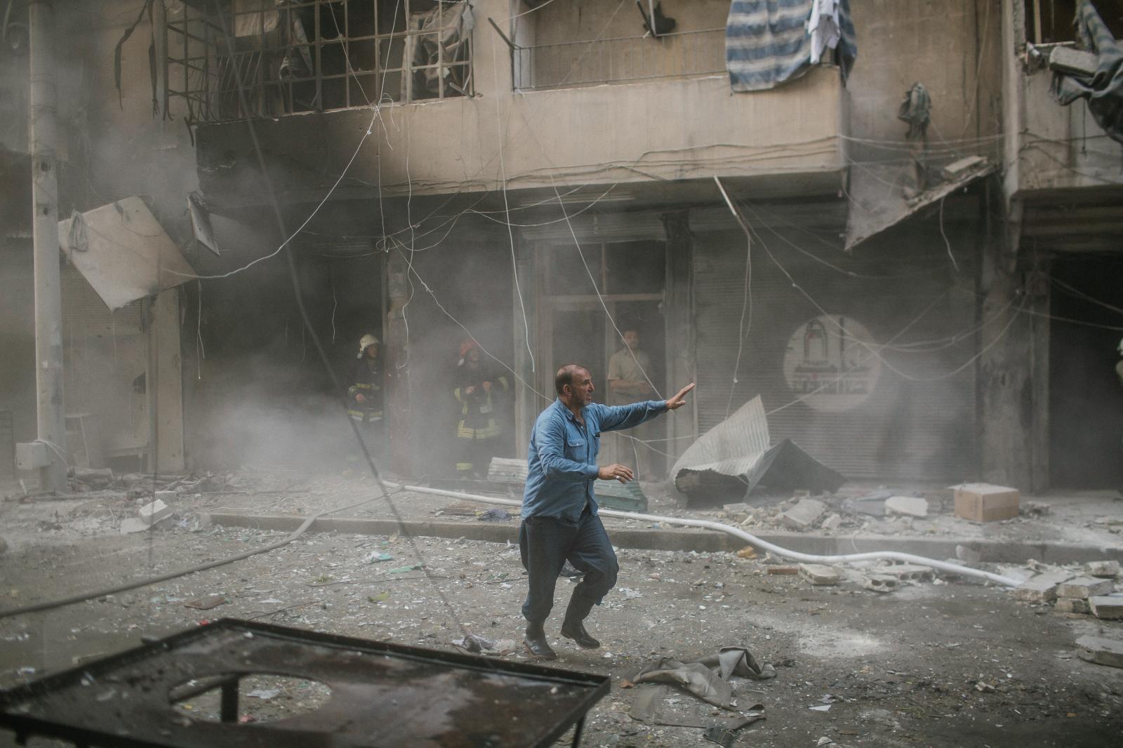 Syria, Aleppo, 9th july 2014. R...ecting themselves to the blast.