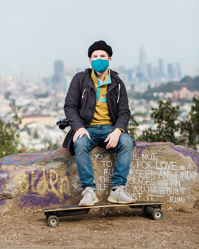 Housing War on The Water - Micah Weiss, a freelance photographer, sits with his camera and electric skateboard at Bernal...