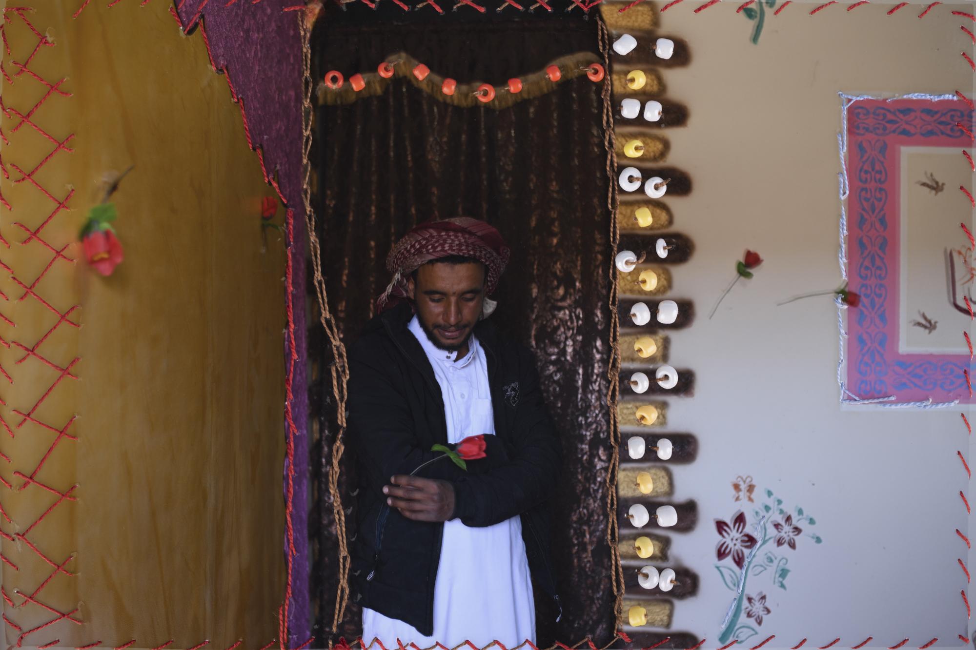 On National Geographic: In one of Egypt's most spiritual places, Bedouins find peace and resilience - An embroidered photograph of Mahmoud Abdo in his home in Al Tarfa Village. His cousin Nora...