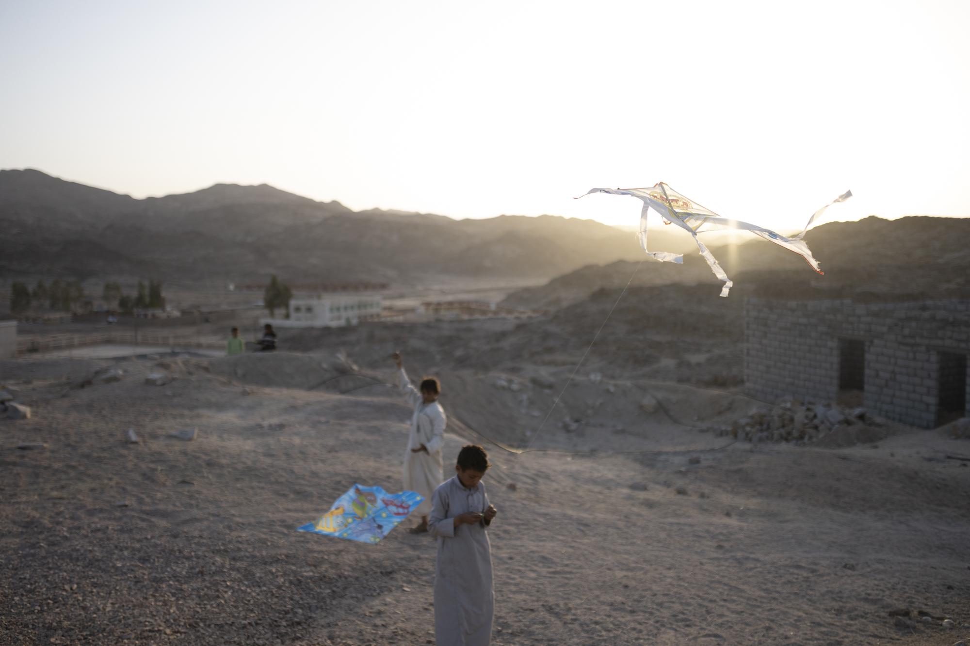 On National Geographic: In one of Egypt's most spiritual places, Bedouins find peace and resilience - Children fly kites on a hill looking over Al Tarfa Village in the Sinai Peninsula, Egypt in April...
