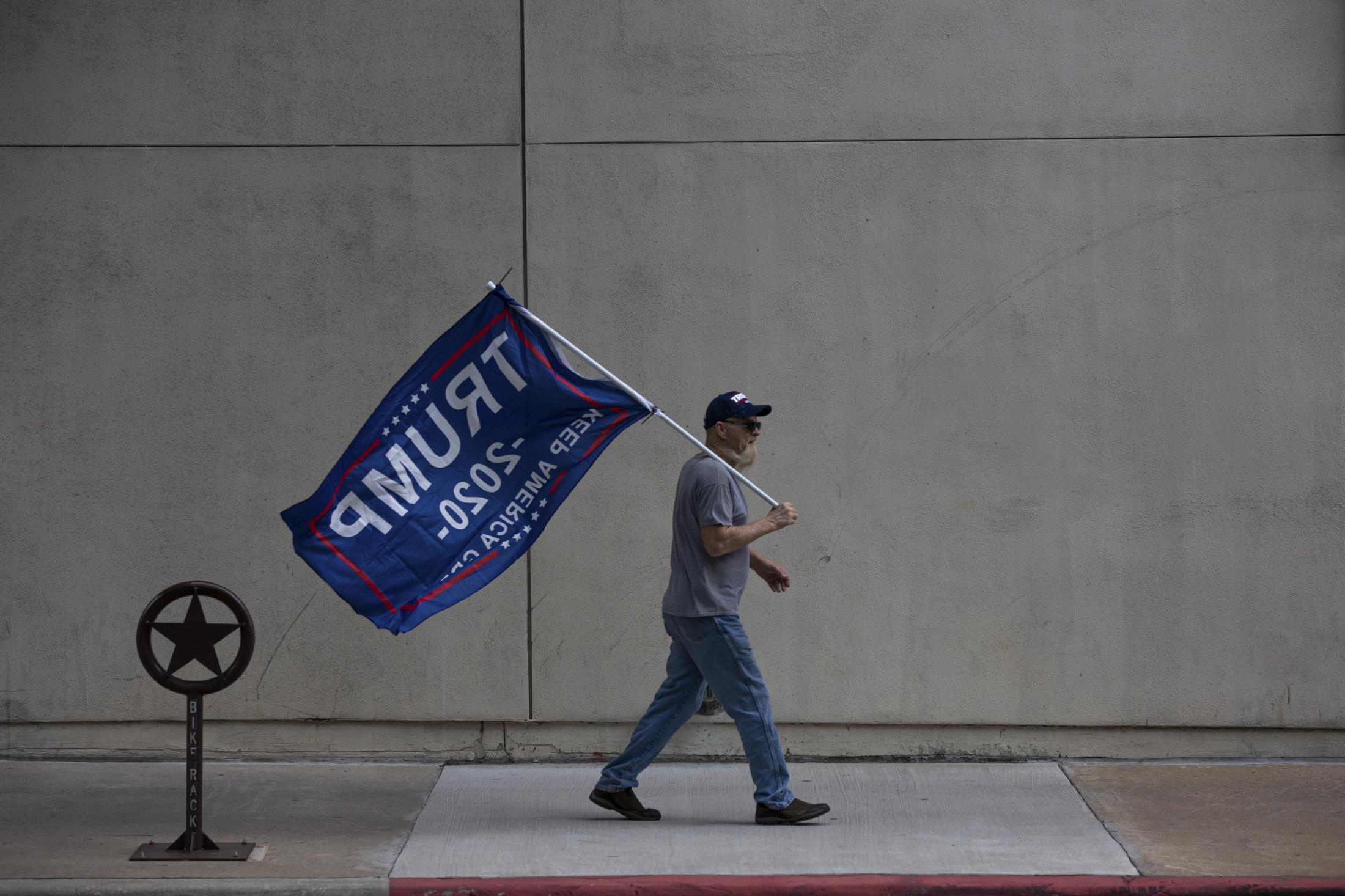 Under The Same Flag - 11/14/20 Fort Worth, Texas - A Trump Supporter holds his...