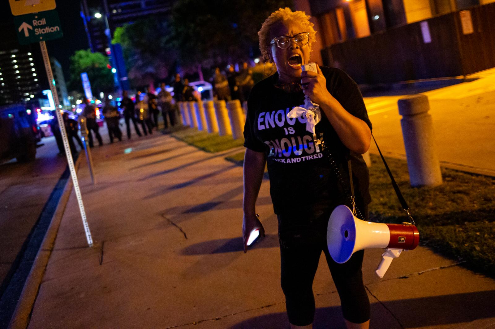 A lone woman screams into a bul...n public by Minneapolis Police.