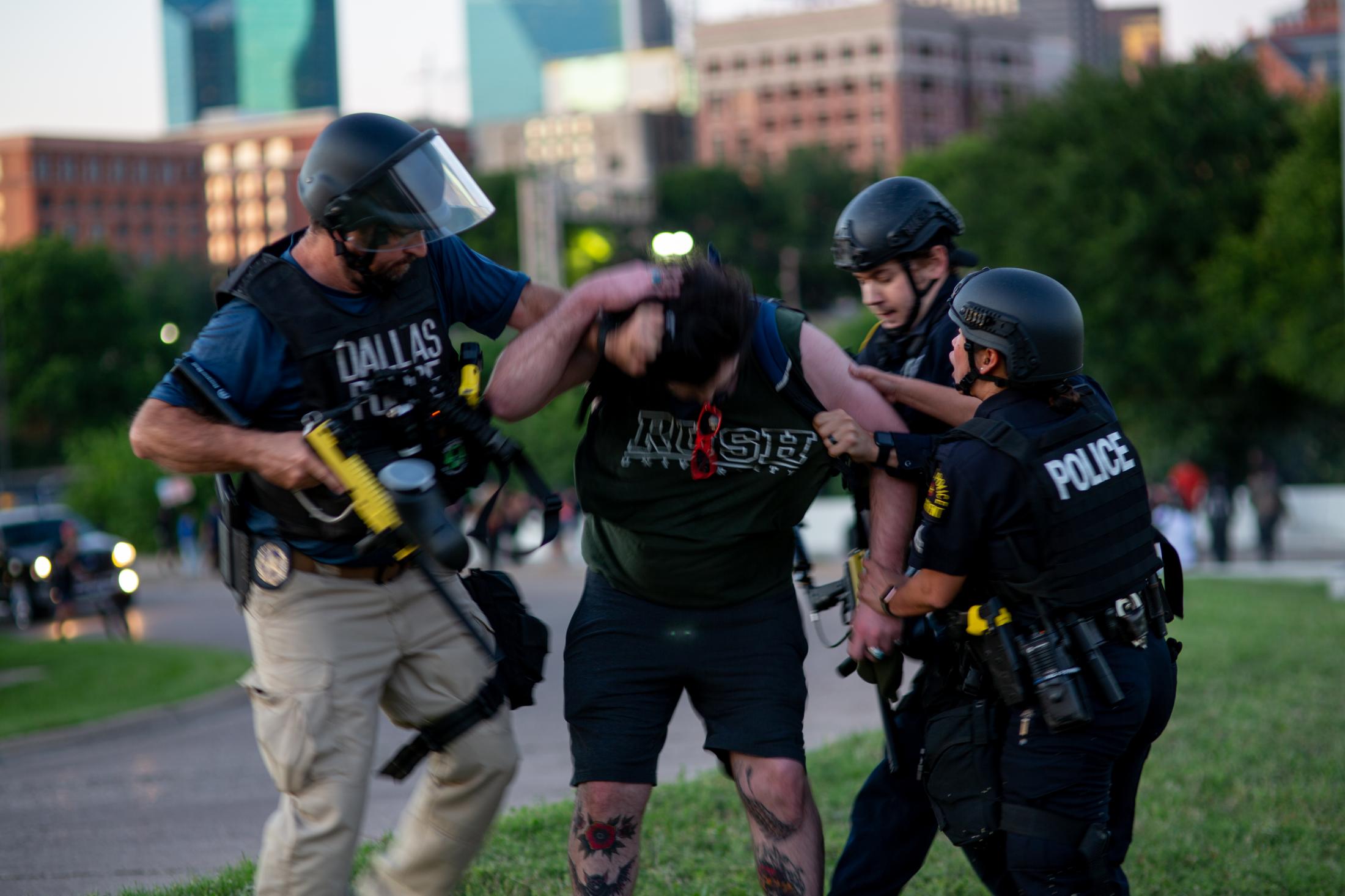 No Justice No Peace - Parker, (center) is grabbed by Dallas Police during the...