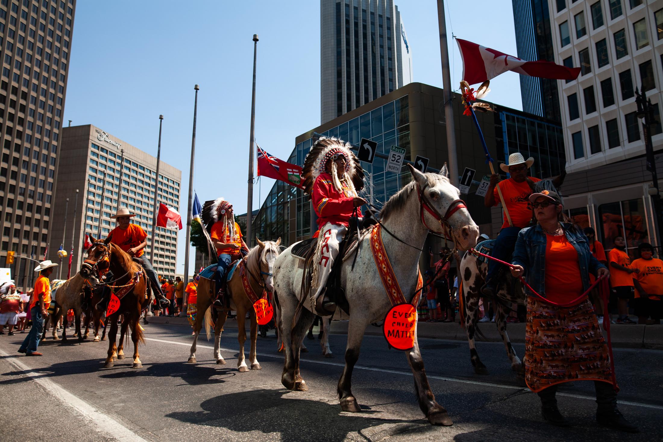 Indigenous chiefs and community leaders ride horses as they head up a march honouring the survivors of residential schools and those who never...