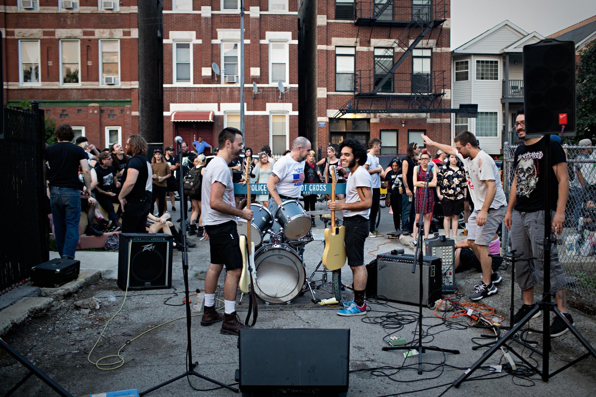 Member of a punk band prepare to play in an alley in Pilsen celebrating the fourth of July.