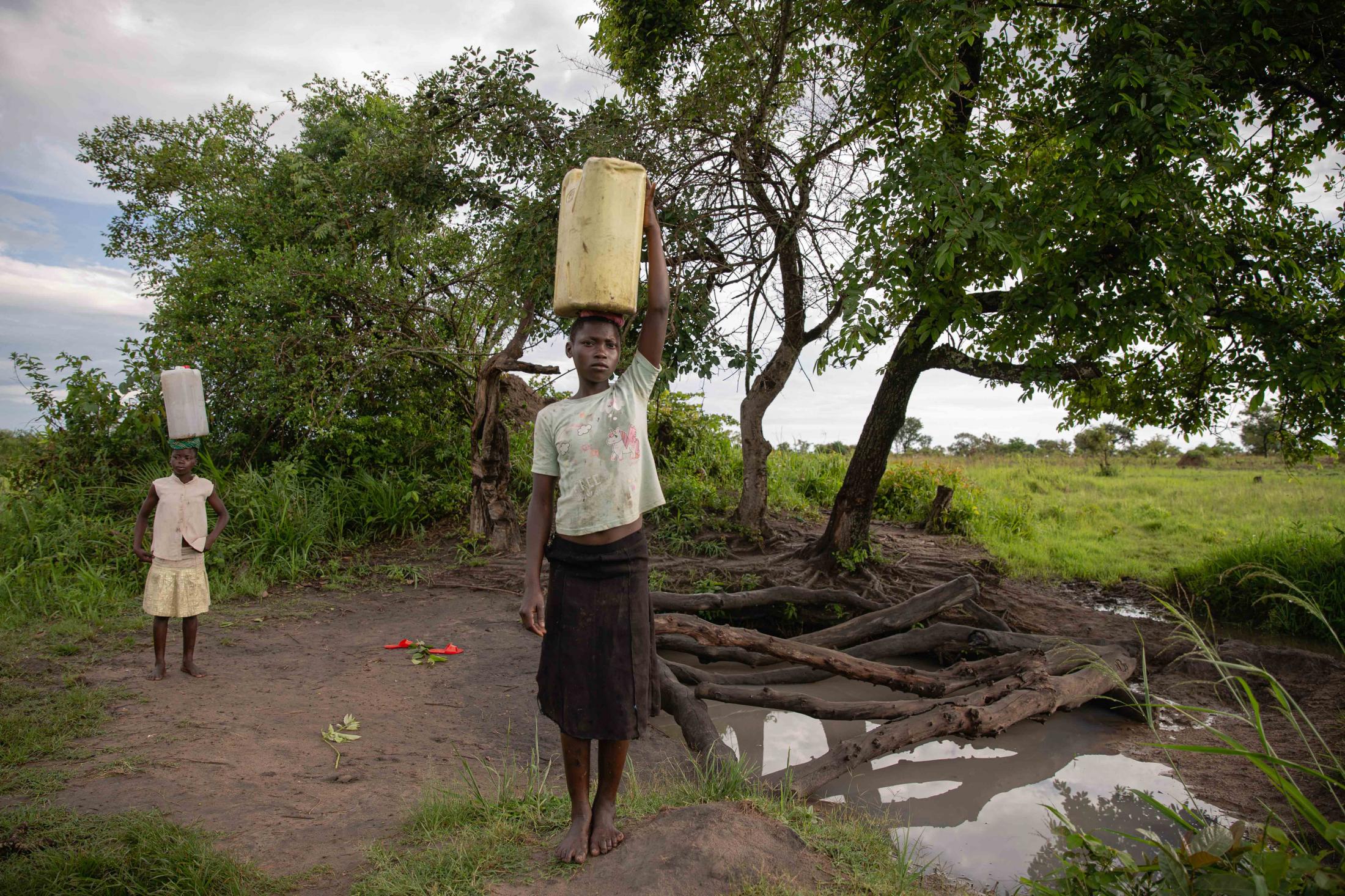 Commissioned Works - Nancy, 14, and her sister Dorothy, 10, fetch water in the...
