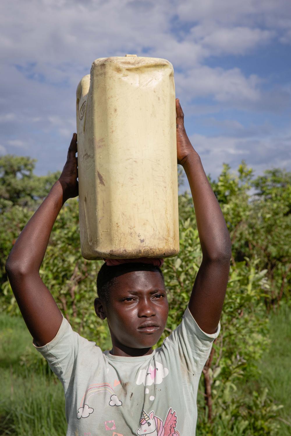 Commissioned Works - Acayo Nancy, 14, fetches water in the morning before...