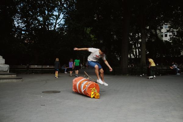 "New York is Back"? - Teen skates over an overturned construction barrel in Washington Square Park. October 2020,...