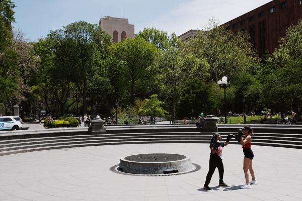 "New York is Back"? - Two women doing boxing exercises at the inactive fountain in Washington Square Park. May 2020,...