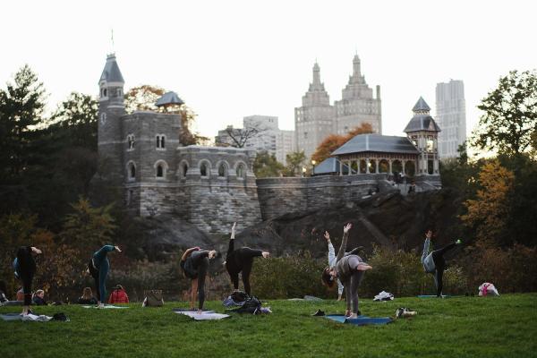"New York is Back"? - An outdoor yoga class taking place in front of the Turtle Pond in Central Park. November 2020,...